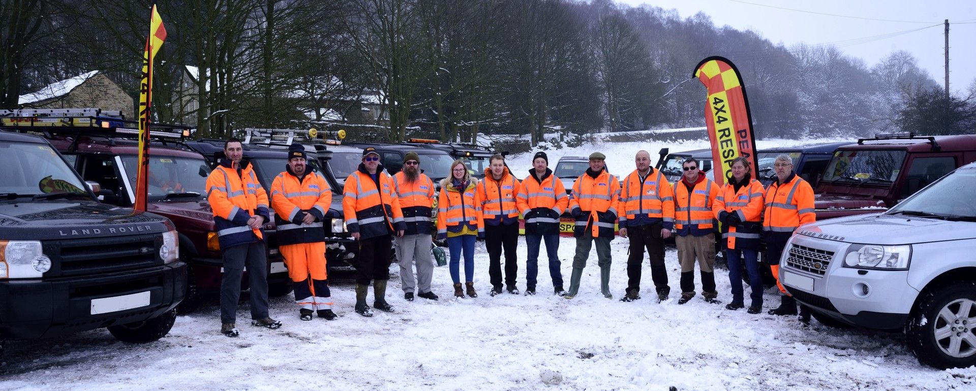 Peak 4x4 Response gathered in the snow with banners flying